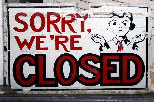 A shop sign that says "Sorry, we're closed"